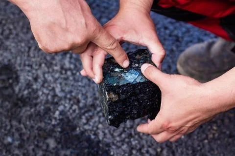Road workers take a cube of asphalt Stock Photos