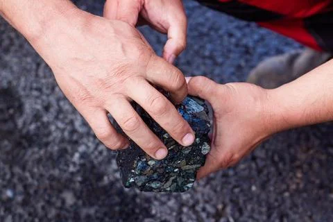 Road workers take a cube of asphalt Stock Photos