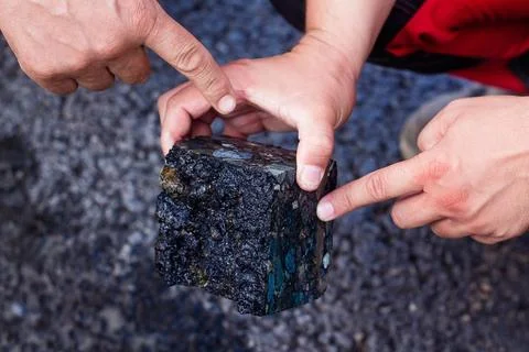 Road workers take a cube of asphalt Stock Photos
