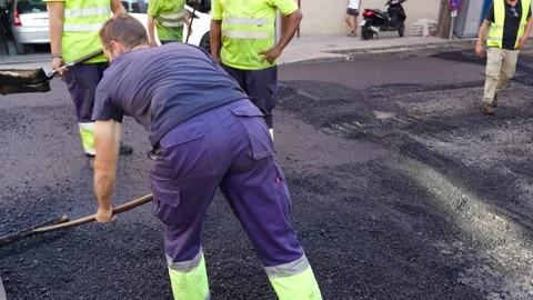 Road workers treating warm mix asphalt during road paving 2 스톡 동영상 253231172