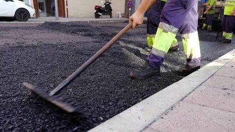 Road workers treating warm mix asphalt during road paving 스톡 동영상 253231195
