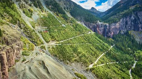 Road zig zagging up steep mountains to waterfalls 스톡 사진