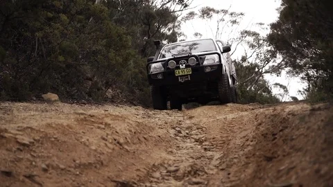 Off roading in a 4WD down a hill in a forest with wheel spin Stock Footage 81603521