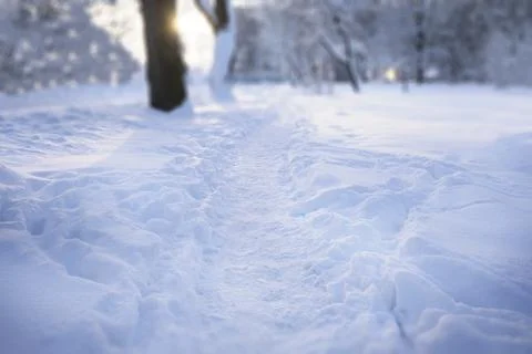 Roads not cleared and covered with snow. Path trodden among snowdrifts. Stock Photos