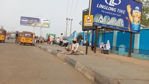 Roadside Beggar With Raffia Hat On Busy Street Kano Nigeria 動画素材 330547985