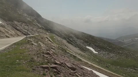 Roadside of moutain with snow with clouds forming Stock Footage 52126871
