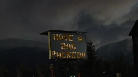 Roadside sign warns active fire danger for Grand Lake, CO evacuation Stock Footage 142015421