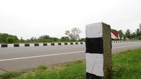 Roadside view of black and white strip traffic control sign board Video stock 156990192