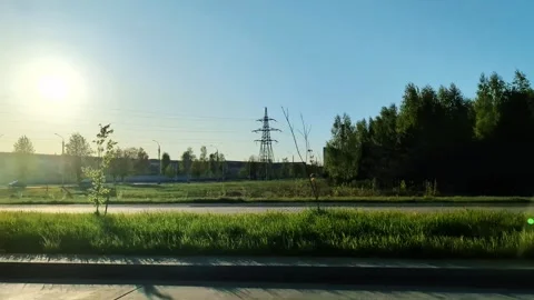 Roadside view from moving car passing urban industrial area with power lines and Stock Footage 342230897