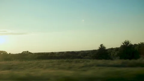 Roadside view of the sunset with tree terrain  Stock Footage 79851489