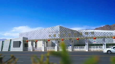 Roadside view of Tibet natural science museum with passing cars Stock Footage 345883508