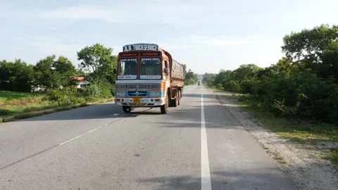 Roadside view of truck carrying load, Truck on Indian roads Stock Footage 156973722