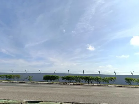 A roadside view under a bright blue sky Stock Photos