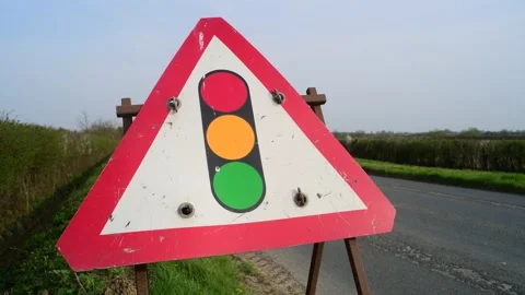 Roadside warning sign of traffic lights in road ahead uk Stock Footage 143843385