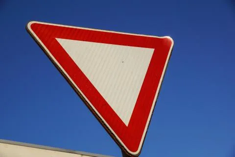 Roadsign, give priority with blue sky in background Stock Photos