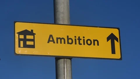 Roadsign pointing to new build housing estate called ambition uk Stock Footage 101729050