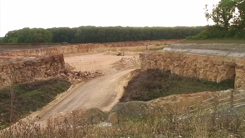 A roadway cutting through a quarry Stock Footage 250562724