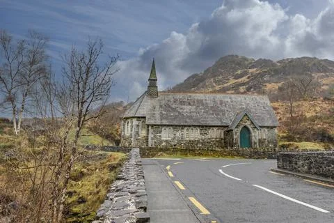 Roadway heading towards a difficult corner with a church Stock Photos