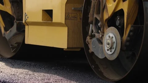Roadway surface compressed by rotating drums of roller-compactor Video stock 158049315