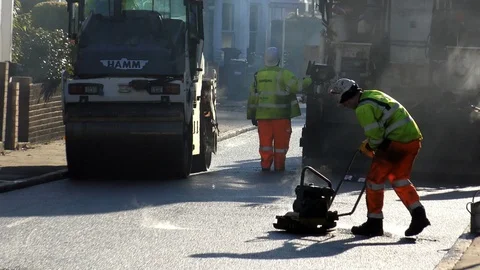 Roadwork Construction Man Working to Laying New Tarmac Paving Stock Footage 70232827