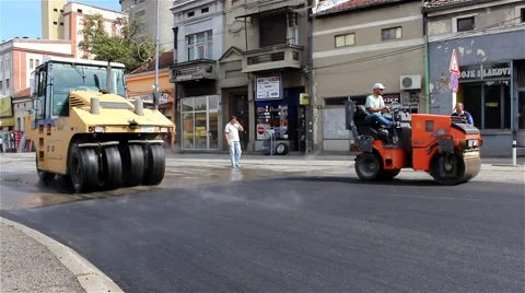 Roadwork, paving and compacting new asphalt, road rollers flattens asphalt. Stock Footage 41488834