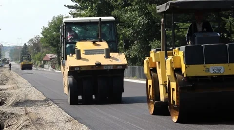 Roadwork. Paving. Road rollers flattens asphalt. Steamrollers smoothing asphalt. Stock Footage 41739305