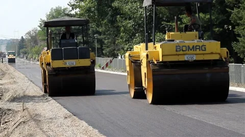 Roadwork. Road rollers flattens asphalt. Steamrollers smoothing asphalt. Paving. Stock Footage 41740981