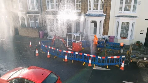 Roadwork Water Leak, pipe broken, an operator working to fix it 4K Stock Footage 116518154