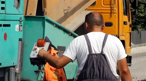 Roadwork. Worker control machine for paving. Asphalting.Construction.Two videos. Video stock 41729883