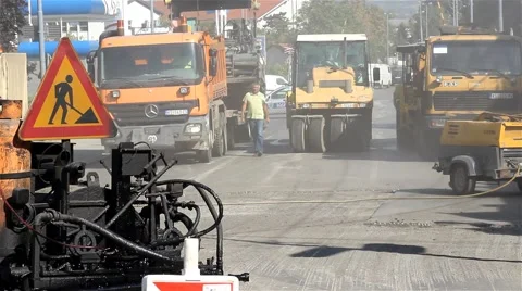 Roadwork. Workers. Machines. Road rollers and trucks preparing for paving street Video stock 41483593