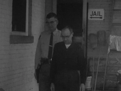 Roanoke, VA - 4/3/59: Man escorted out of jail (slow motion) Stock Footage 234233918