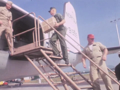 Roanoke, VA - 5/13/68: Boxes loaded onto military plane Stock Footage 233725951
