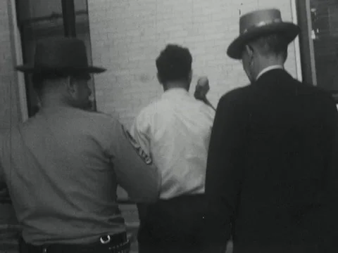 Roanoke, VA - 6/24/58: Man escorted into jail Stock Footage 234240108