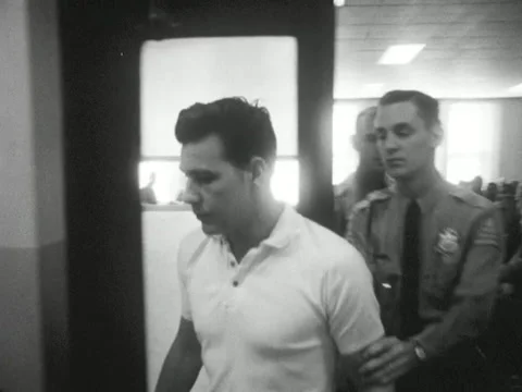 Roanoke, VA - 9/27/63: Man escorted from courtroom to jail Stock Footage 234236928