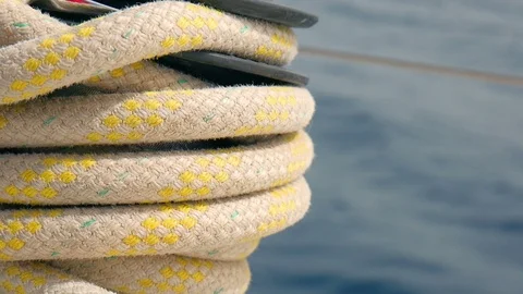 Roap with yellow stripes winded on sailing boats side winch. Stock Footage 90326426