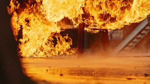 Roaring fire burns over gas tank in slow motion Stock Footage 168462032