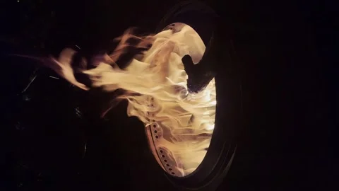A roaring fire in a stainless steel firepit at night. Stock Footage 317303482