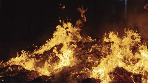 Roaring Flames Burning Over Massive Glowing Ash Bed at Night Video stock 346178002