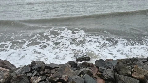 Roaring waves hitting the rocks and splashing Stock Footage 302584631