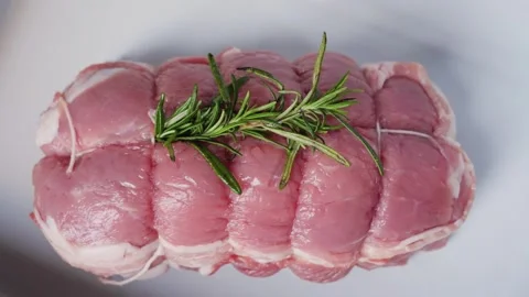 Roast beef with bacon and with a sprig of rosemary close up. Stock Footage 330947854