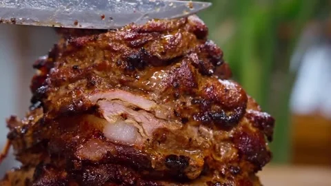 Roast beef being sliced ​​thinly using a large knife. Video stock 329530129