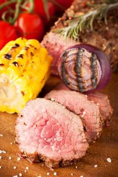 Roast beef with cherry tomatoes, corn and spices Stock Photos