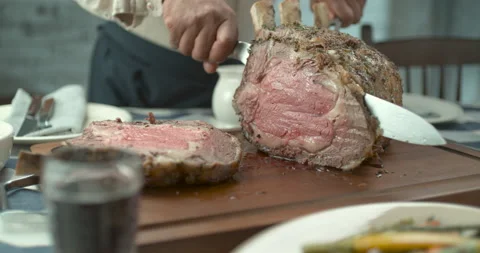 Roast beef with ribs being sliced with knife in ultra slow motion closeup with 4 Stock Footage 199457038