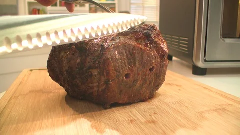 Roast. Chef cuts meat in kitchen. cu Stock Footage 101712540