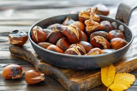 Roast chestnuts in a pan closeup. Stock Photos