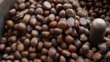 Roast chestnuts in roasting machine. Stock Footage 85943942