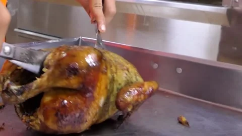 Roast chicken cut by human hands and a scissors, traditional Peruvian food. Video stock 154727944
