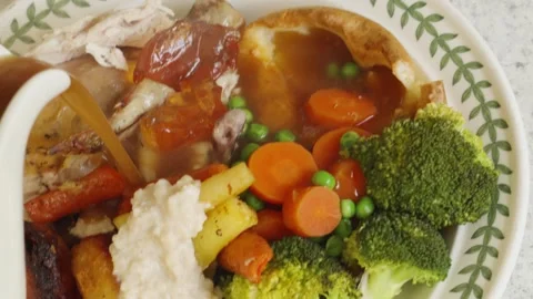 Roast Chicken Dinner with Slow Motion Gravy Pour with Fresh Vegetables with Stock Footage 333942692