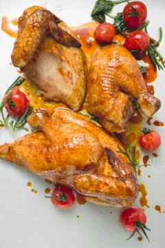 Roast chicken, jointed, with cherry tomatoes Stock Photos