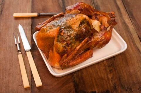 Roast chicken on a rectangular plate with carvers Stock Photos